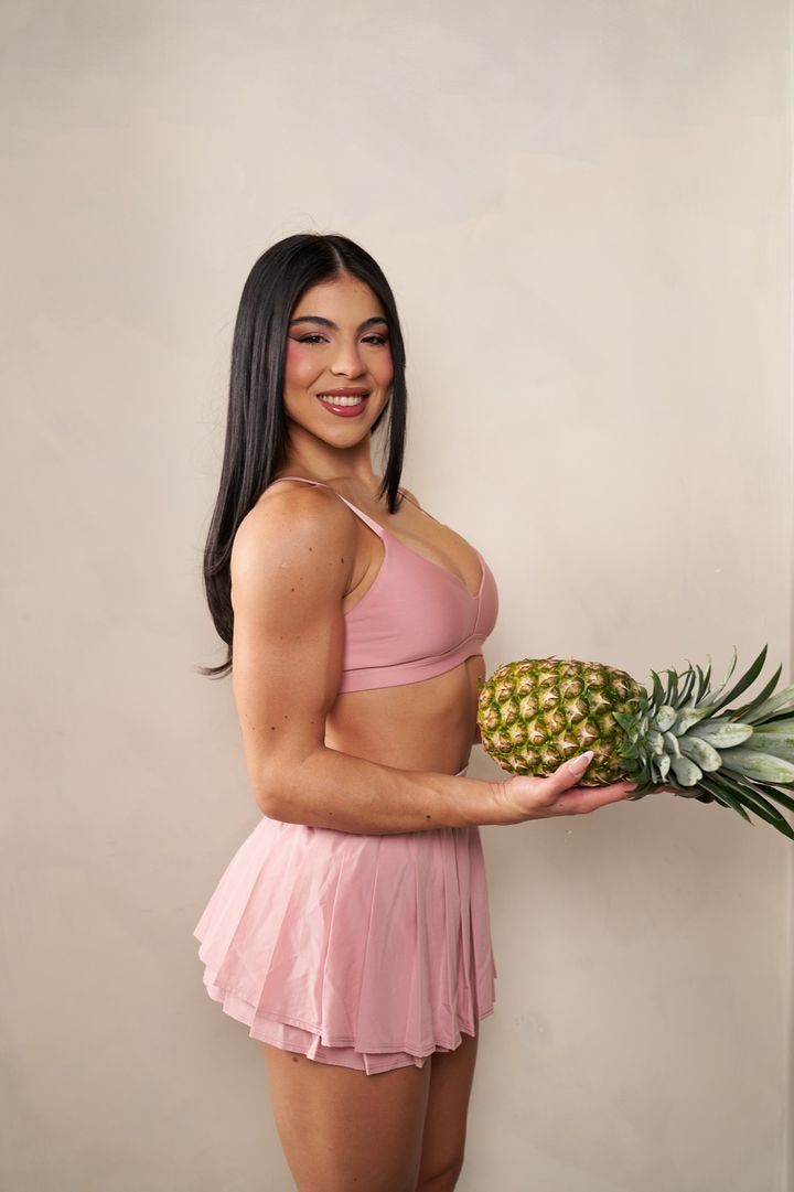 Diana Sosa smiling and holding a pineapple